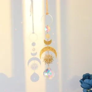 Crystal suncatcher detail hanging prism window ornament featuring glowing light and faceted rainbow ball.