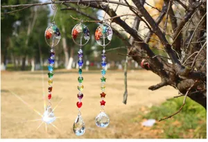 Crystal suncatcher hanging pendant featuring a life tree and vibrant crystals for garden decor.