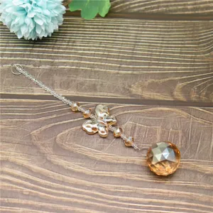Crystal suncatcher detail showing amber faceted ball, golden butterfly and clear bead chain.
