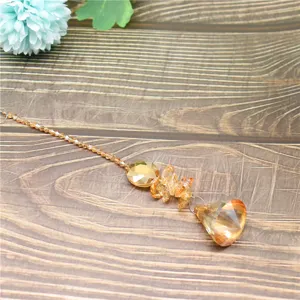 Crystal suncatcher pendant detail showing faceted amber beads and prism drop for garden decor.