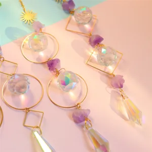 Exquisite crystal suncatcher detail showing faceted prism balls and natural raw amethyst stones.