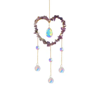 Natural crystal stone heart wind chime suncatcher with rainbow prisms for garden decor.