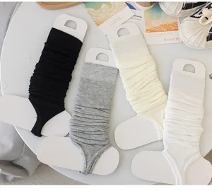 Cotton ballet style stirrup leg warmers detail showing four neutral colors on white card display.