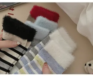 Detailed shot of cozy plush striped mid-calf socks with fuzzy cuffs and colorful confetti dots.