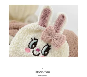 Close-up of cute fluffy bunny plush floor socks with 3D ears and sweet bow detail for winter.