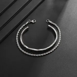 Men silver two-piece bracelet set featuring textured open cuff and detailed rope chain design.