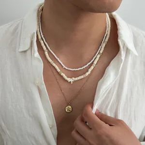 Close-up detail of layered beaded necklace with starfish pendant for men beach style.