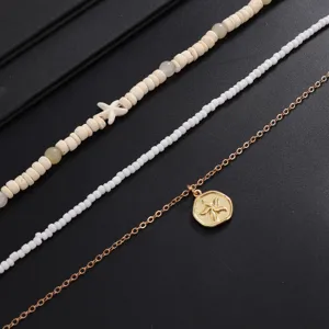 Detailed view of multi-layered beach style starfish necklace set with wooden and seed beads.