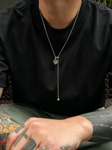Closeup detail of men's stainless steel cube lariat necklace, showing chic hip-hop design.