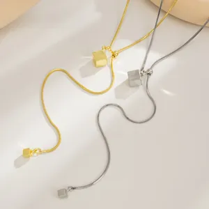 Close-up detail of stainless steel square pendant snake chain necklace with adjustable sliding bead.