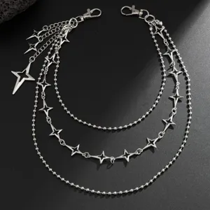 Closeup of multi-layer metal pants chain with four-point star charms and secure lobster clasps.