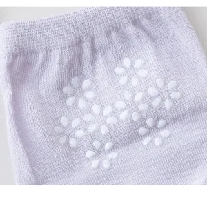 Close-up of breathable mesh half socks with white floral anti-slip silicone grips for heels.