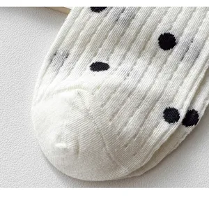 White polka dot mesh cotton sock close-up, breathable ribbed texture summer detail view.
