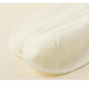 Close-up detail shot of womens summer thin breathable knit boat socks in cream white color.