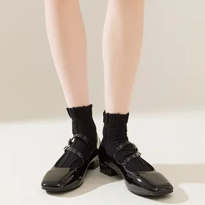 Womens thin black short socks paired with classic patent leather Mary Jane shoes main