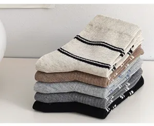 Vue rapprochée détaillée de chaussettes rayées en coton empilées, texture de tissu douce.