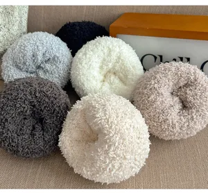 Detail shot of multi-color cozy fluffy fleece socks rolled up neatly for winter warmth.