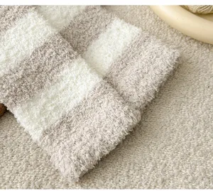 Gemütliche gestreifte flauschige Beinwärmer Detailansicht, weicher Plüsch-Winter-Accessoire.