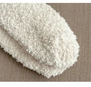 Cozy fleece sock detail close-up showing soft textured fluffy fabric for warm winter home wear.