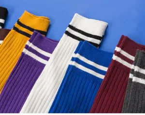 Close-up detail view of colorful ribbed knee-high socks featuring classic double stripes design.