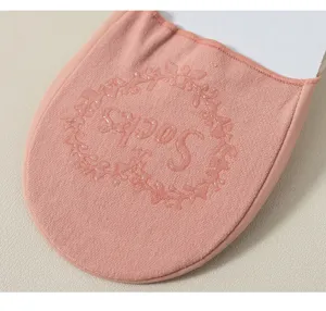 Detail view of pink women's invisible boat socks with anti-slip silicone floral sole print.