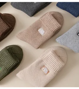 Close-up detail of cozy men's winter wool terry socks with delicate embroidery, warm knit texture.