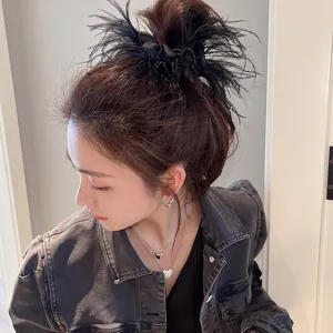 Feather hair scrunchie detail shot, stylish black hair accessory for women daily wear look.