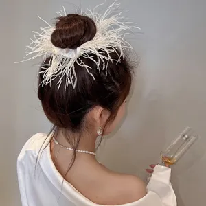 Detailed shot of white ostrich feather hair scrunchie worn on bun, elegant style.