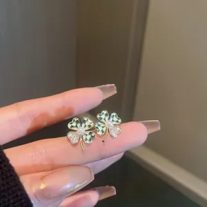 Close-up detail view of elegant green white clover pearl rhinestone stud earrings design.