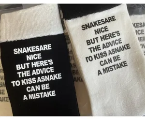 Black and white letter print mid-tube cotton socks close-up detail showcasing style.