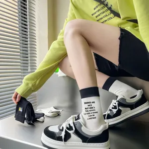 Cotton mid-tube socks with letter print, stylish black and white streetwear skateboard socks.