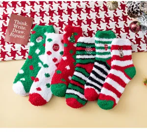 Close-up view of thick cozy Christmas coral fleece socks with cute patterns for indoor winter wear.