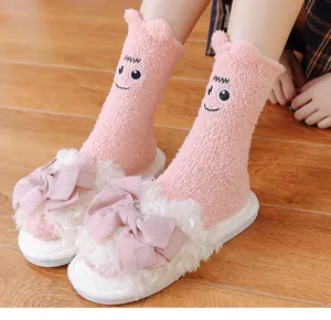Fluffy coral fleece mid-tube socks with cute cartoon big eye design and warm winter comfort.