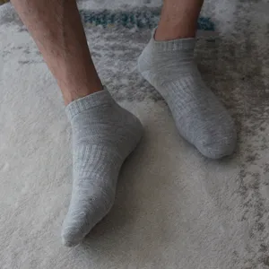 Cómodos calcetines deportivos grises cortos para correr y uso diario de algodón suave.