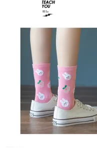 Cute pink mid-calf cotton socks featuring adorable white bunny and peach graphic prints for women.
