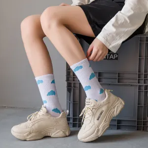Cute blue cloud print white cotton mid-tube socks paired with stylish beige sneakers for daily wear.