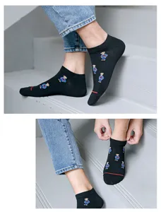 Detailed view of black novelty low-cut socks featuring cute bear embroidery design.