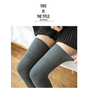 Detail view of grey knit over-the-knee socks, vintage chunky wool texture for warmth and style.