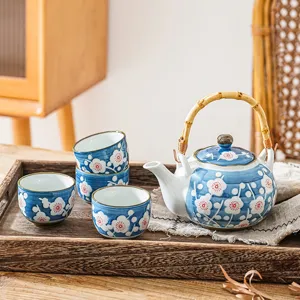 Handmade ceramic tea set with teapot and four cups, blue plum blossom pattern for home and office.
