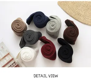 Detail view of women's knitted over-the-knee socks, multi-color cozy high tube socks set.