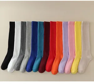 Details of colorful solid cotton calf socks in various vibrant shades and ribbed knit pattern.