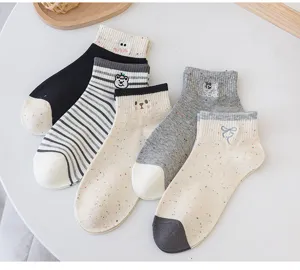 Detail view of women's spot yarn cartoon embroidered short socks, cute striped cotton socks.