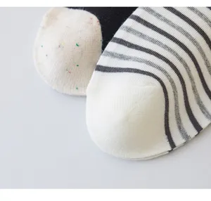 Close-up detail of women's striped and speckled cotton socks showing fine knit texture.