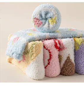 Detail shot of cute coral fleece fuzzy sleep socks in pastel colors, soft and warm winter home.