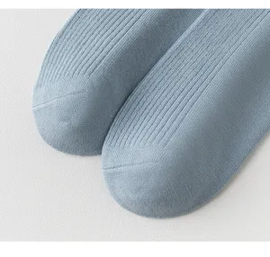 Detailed shot of women's light blue ribbed cotton socks, soft knit texture and solid color.