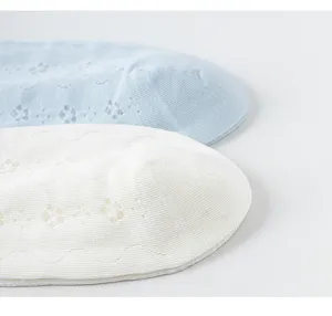 Close-up detail of thin cotton socks with delicate mesh floral knit patterns for summer style.