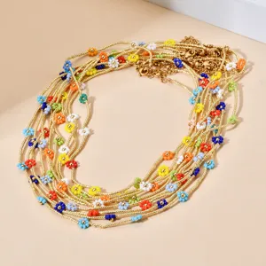 Detailed view of the layered bohemian seed bead necklace with colorful daisy flower charms.