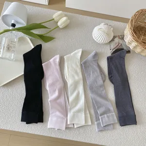 Women's long ribbed knit socks, stylish high tube stockings, solid colors for daily wear.