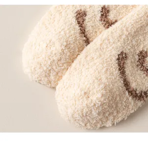 Cozy plush coral fleece sleep socks detail, soft warm winter home floor socks texture.