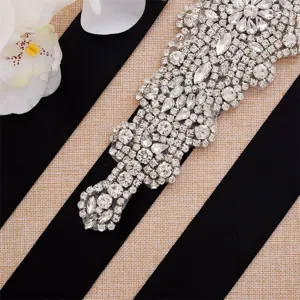 Close-up detail of silver rhinestone bridal belt sash sparkling crystals wedding accessory.